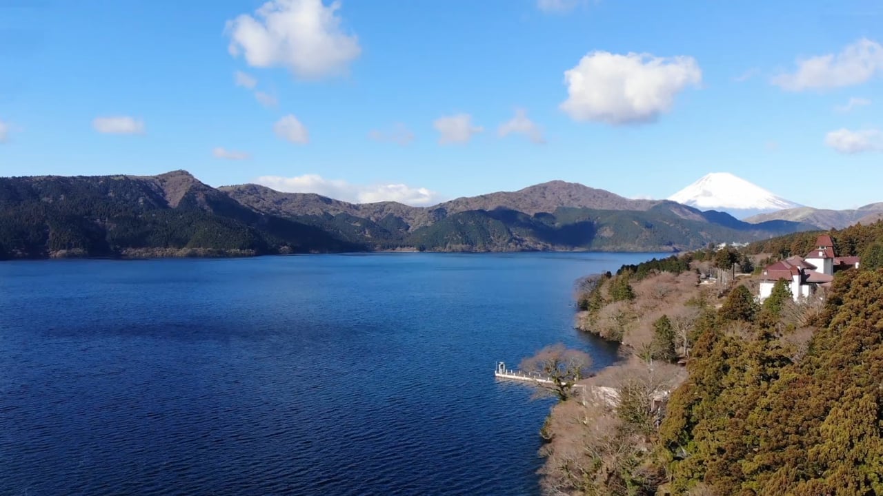 Lake Ashi, forested hills and Mount Fuji beneath a blue sky